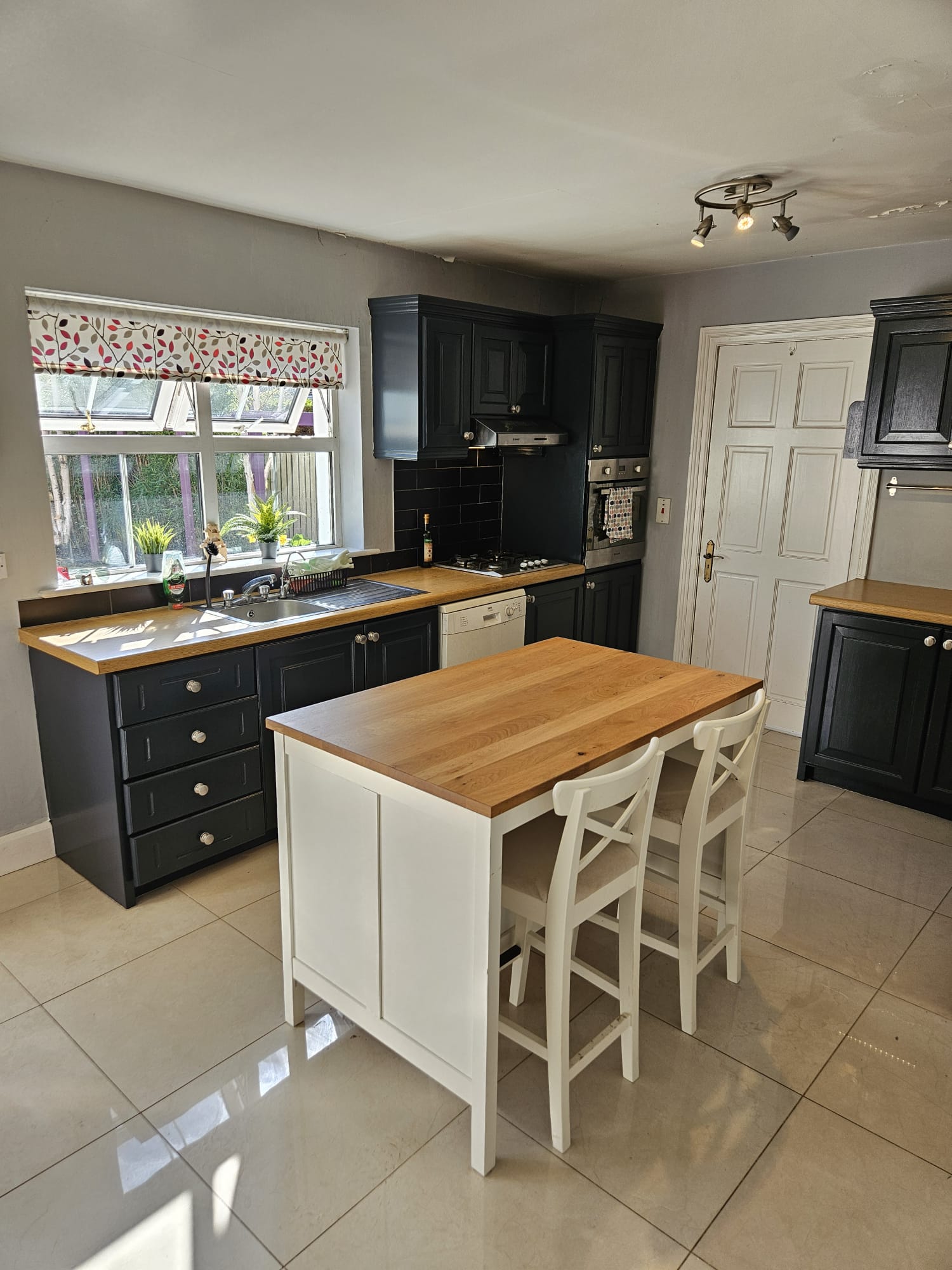 Sage green hand painted kitchen with decorative tiles in Limerick