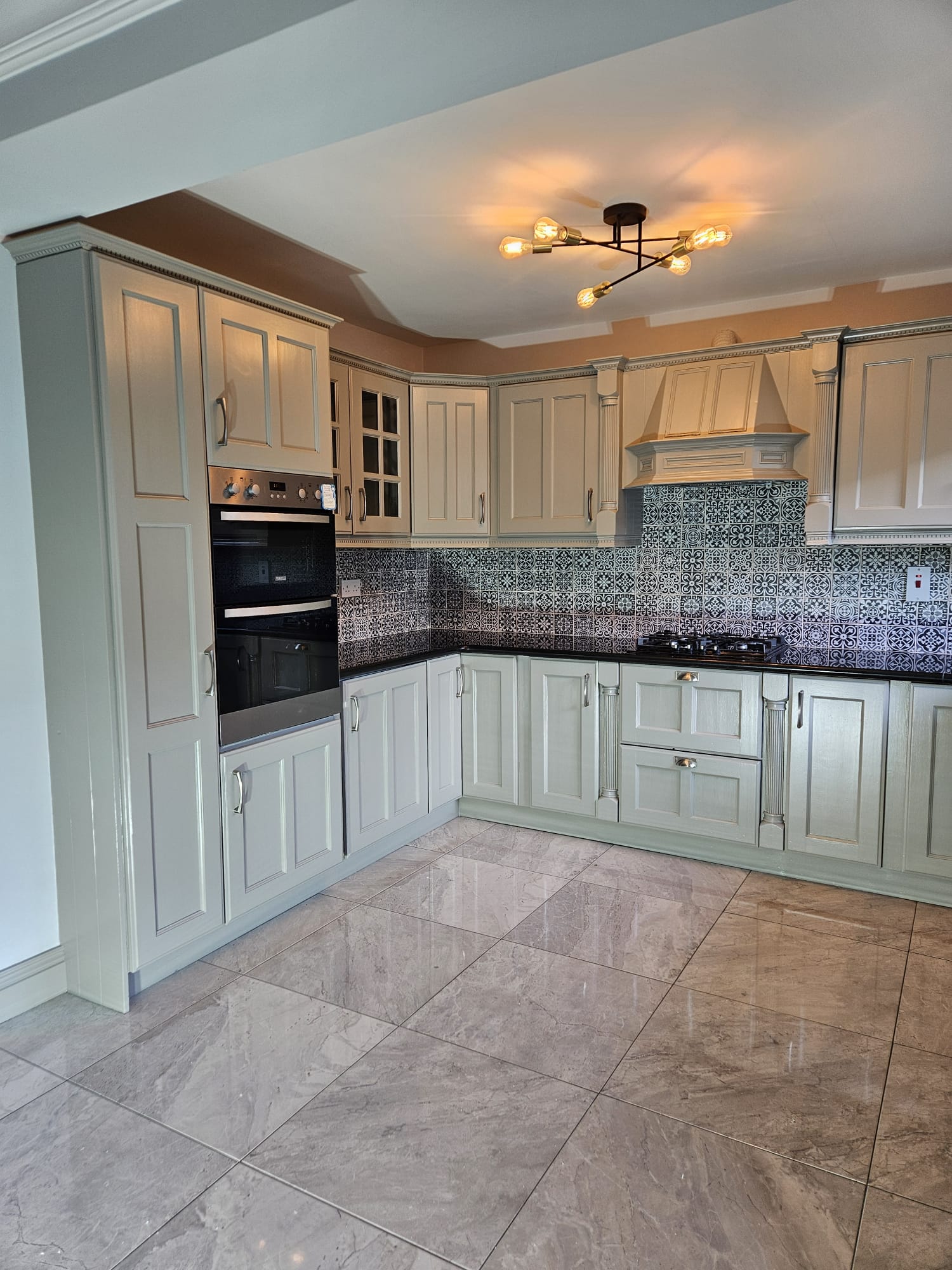 Sage green hand painted kitchen with decorative tiles in Limerick